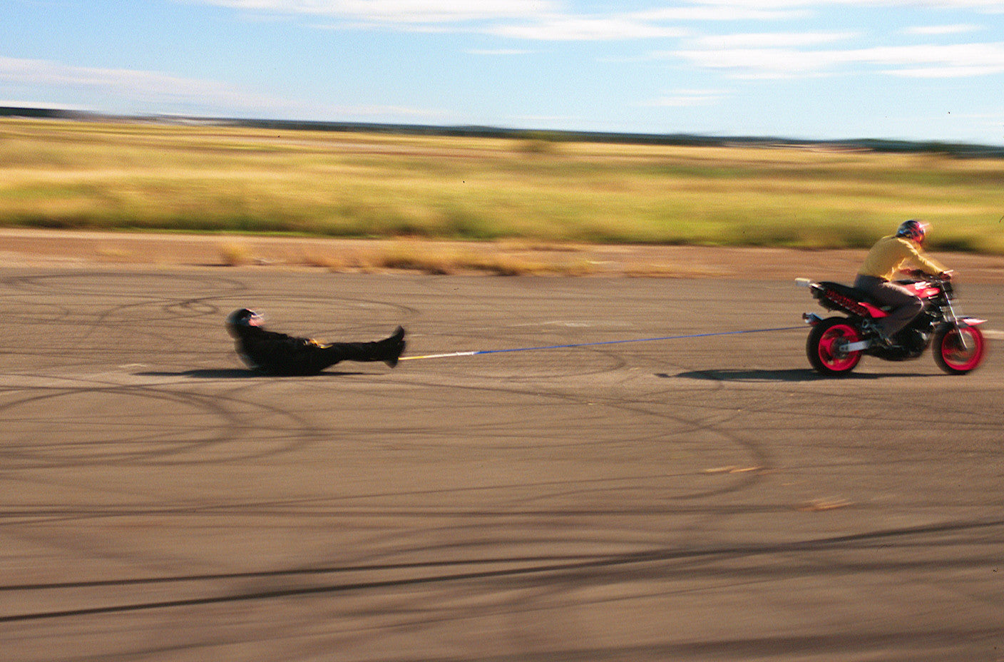 Draggin drag test, with person being dragged behind a motorcycle